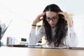 Tired woman with headache work with document at workplace in office.