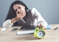 Tired woman hand clock on desk