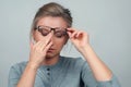 Tired woman has eyes pain. Optician and eyeglasses Royalty Free Stock Photo