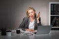 Tired woman having boring phone conversation at work Royalty Free Stock Photo