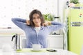 Tired woman having breakfast at home Royalty Free Stock Photo