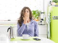 Tired woman having breakfast at home Royalty Free Stock Photo