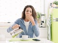 Tired woman having breakfast at home Royalty Free Stock Photo