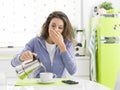 Tired woman having breakfast at home Royalty Free Stock Photo