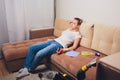 Tired woman having rest after cleaning home, lying on sofa in the living-room, copy space. Housekeeping and home Royalty Free Stock Photo