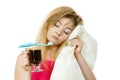 Tired woman holding toothbrush and coffee