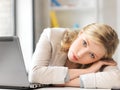 Tired woman with laptop computer