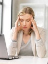 Tired woman with laptop computer