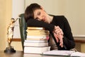 Tired woman lawyer in the office with books and documents Royalty Free Stock Photo