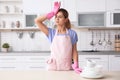 Tired woman near table with clean dishes and cups Royalty Free Stock Photo