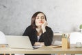 Tired woman at office desk