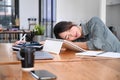 Tired woman office worker having a nap at her office desk. Royalty Free Stock Photo