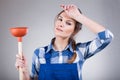 Tired woman with a plunger Royalty Free Stock Photo