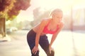 Tired woman, rest and fitness with break in city after workout, running or cardio exercise. Exhausted or determined Royalty Free Stock Photo