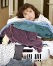 Tired woman resting on pile of laundry