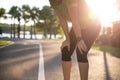 Tired woman runner taking a rest after running hard and workout session on sunny morning. Sports and Recreation concept Royalty Free Stock Photo