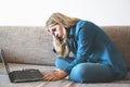 Tired woman sitting with laptop, lazy student doing homework Royalty Free Stock Photo