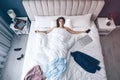 Tired woman sleeping in bed at home after work, above view Royalty Free Stock Photo