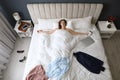 Tired woman sleeping in bed at home after work, above view Royalty Free Stock Photo