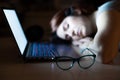 Tired woman sleeping at workplace near laptop. girl dozed off for remote work. Overworked student fell asleep on the Royalty Free Stock Photo