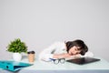 Tired woman sleeping at workplace. Overworked female entrepreneur give up after hard day and dozing at desk. Stressed business Royalty Free Stock Photo