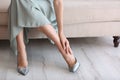 Tired woman taking off shoes at home Royalty Free Stock Photo