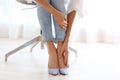 Tired woman taking off shoes at office Royalty Free Stock Photo