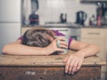 Tired woman with tea in kitchen Royalty Free Stock Photo