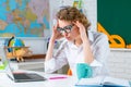 Tired woman teacher in classroom. Education and Teachering concept. Royalty Free Stock Photo