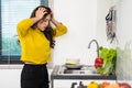 Tired woman washing dishes in the sink in kitchen at home Royalty Free Stock Photo