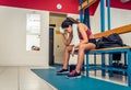 Tired woman after a workout in the gym locker room