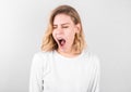 Tired woman yawning covering open mouth with hand need rest