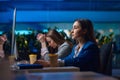 Tired women sitting at the table in night office