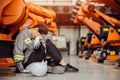 Tired worker exhausted woman worker fatigue engineer labor nap from hardwork late overnight in machine factory Royalty Free Stock Photo