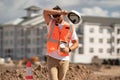 Tired worker. Worker man on the building construction. Construction site worker in helmet work outdoors. Builder worker Royalty Free Stock Photo