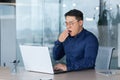 Tired worker at work yawning, asian man in shirt and glasses working inside office using laptop, man sleepless at work Royalty Free Stock Photo