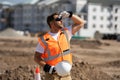 Tired worker. Worker man on the building construction. Construction site worker in helmet work outdoors. Builder worker Royalty Free Stock Photo