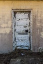 Tired worn out old wooden door on side