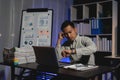 Tired and worried business man at workplace in office looking on his watch after late night work Royalty Free Stock Photo