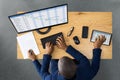 Tired Young African Man Doing Multitasking Work On Laptop