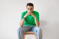 Tired young arab man yawning, exhausted guy covering mouth with hands, feeling bored and sleepy, sitting on chair Royalty Free Stock Photo