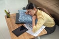 Tired Asian businesswoman sleeping on the table at her house, Napping overworked female in living room, work from home, business Royalty Free Stock Photo