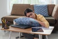 Tired Asian businesswoman sleeping on the table at her house, Napping overworked female in living room, work from home, business Royalty Free Stock Photo