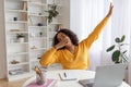 Tired young black female student yawning in front of laptop during online lesson at home Royalty Free Stock Photo