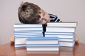 Tired young boy and books Royalty Free Stock Photo
