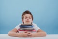 Tired young boy and books. Tired young boy sitting and sleeping Royalty Free Stock Photo