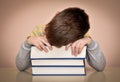 Tired young boy and books Royalty Free Stock Photo