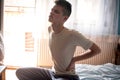 Tired young boy is sitting in bed Royalty Free Stock Photo