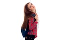 Tired young brunette student girl with blue backpack posing and looking at the camera isolated on white background Royalty Free Stock Photo