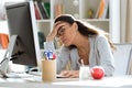 Tired young business woman having headache while working with computer in the office Royalty Free Stock Photo